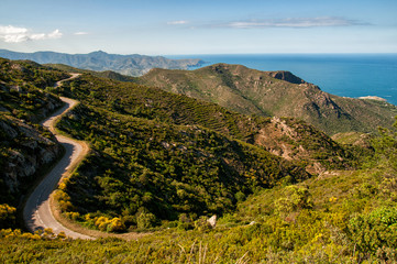 Fototapeta na wymiar Winding road through mountains in the coast of Cap de Creus, Girona, Spain
