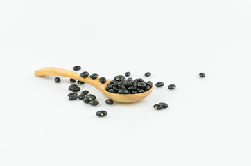 Black beans in wooden spoon