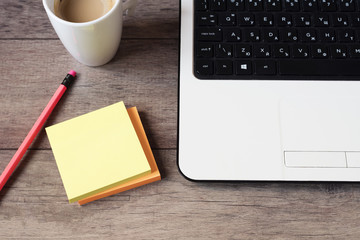 Image of Wood Office Desk with laptop Keyboard, Pretty pink office accessories ? stickers, color pencils. Supplies Top View. Business and workplace concept. Modern Office Desktop