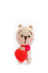 crochet doll of a bear holding a red heart, concept of love and romantic for Valentine's day or happy anniversary.