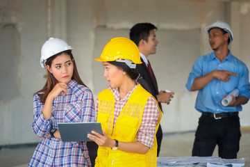 Asian construction engineer and Asian foreman worker checking construction site for new Infrastructure construction project