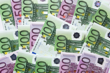 European money of different denominations lie on the table mixed.