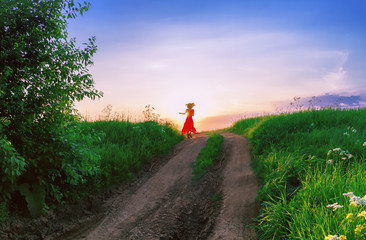 Young Woman Dancing Against The Setting Sun