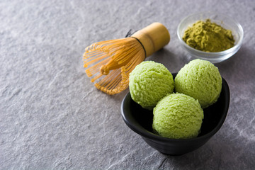 Green tea matcha ice cream scoops on gray stone background.Copyspace

