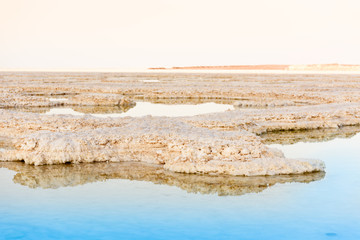 View of Dead Sea coastline. Salt crystals at sunset. Texture of Dead sea. Salty sea shore