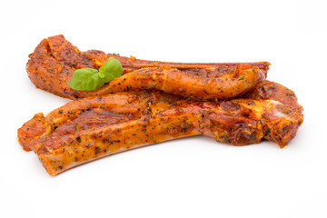 Spicy marinated spare ribs barbecued on the white background.