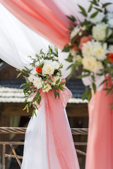 at the wedding ceremony decorations of roses and chrysanthemums