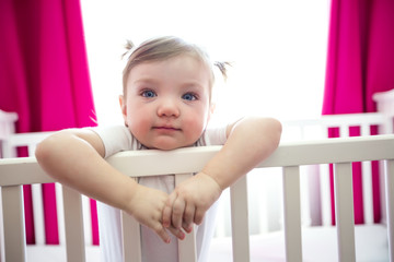 Cute little girl in cradle at baby room