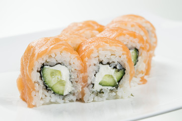 Sushi rolls with salmon and cucumbers in the middle