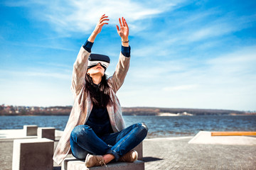 Pretty girl outdoor enjoying virtual reality glasses