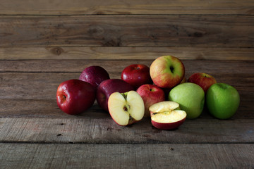 Pile of fresh apple put on old wooden background in dim light, Still life and select focus..