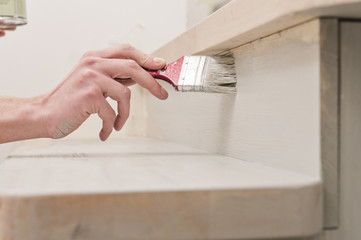 hand with brush for painting works