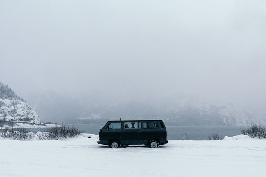 Black camper van, stationary, misty, snowy landscape, Alaska, United States of America 