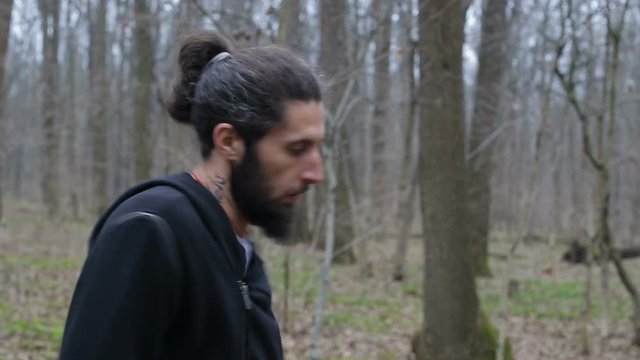 The fighter trains a punch and beats his fists in the tree