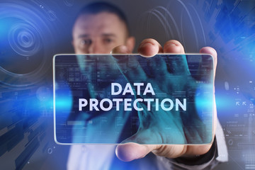 Business, Technology, Internet and network concept. Young businessman working on a virtual screen of the future and sees the inscription: Data protection
