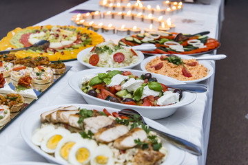 Colorful canape with vegetables and sausage on a slate plate