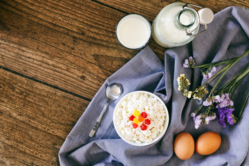 Dairy products on dark wooden table. Sour cream, milk, cheese, egg. Top view with copy space