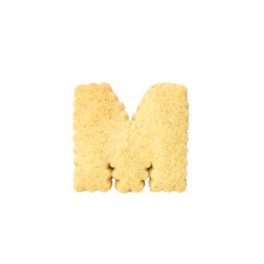 Closeup brown cookie in M english alphabet isolated on white background with clipping path