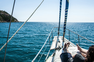 panoramic ocean and landscape shot front of the yacht in summer time in italy sardinia with girl