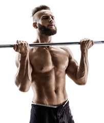 Attractive muscular guy doing exercises with barbell isolated on white background. Strength and motivation