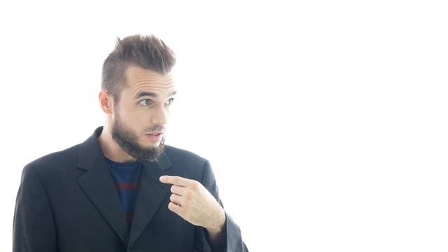 Incredulous surprised bearded man in suit pointing at himself, studio isolated on white background.