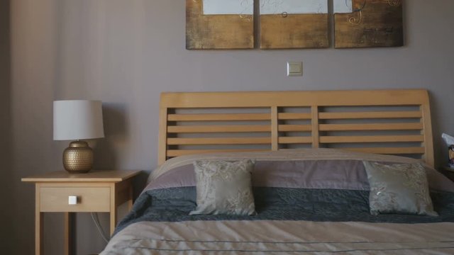 Wooden bed with large cover in the stylish room