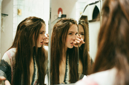 Girl confronts her vanity in a house full of mirrors