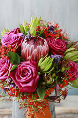 Rose and protea flowers in wedding bouquet.