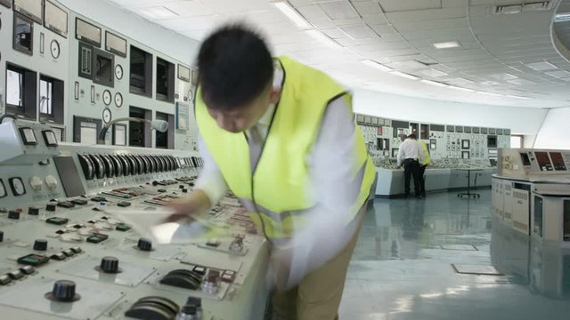  Time lapse of busy team of engineers working together inside power station