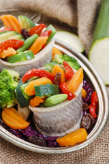 Pickled herring rolls with vegetables.