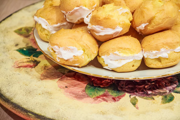 Close up of resh homemade profiteroles with cream