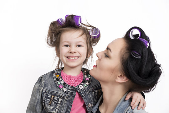 Mother and little daughter in hair curlers