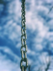 Steel Chain against dramatic cloudy sky 