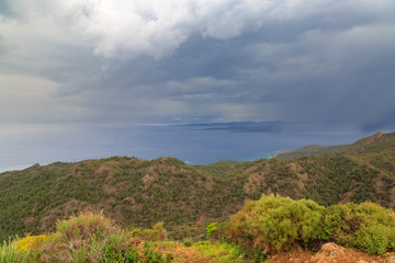 Fototapeta na wymiar Rain clouds with distance in Datca mountains