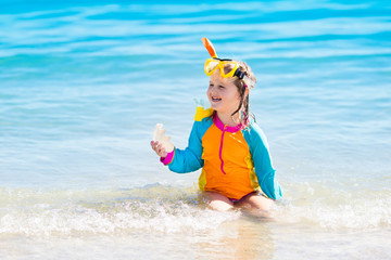 Child snorkeling on tropical beach