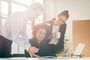 Obraz premium Young female employee asking for advice her experienced colleagues