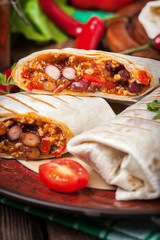 Burritos filled wiht minced meat, bean and vegetables.