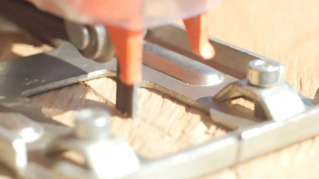 Close-up of a circle of plywood with an automatic jigsaw close-up of a macro on a sunny day