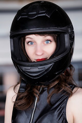 Young Vibrant Intense Girl in black Face Motorcycle Racing Helmet