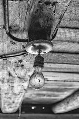 Dirty old light bulb in a barn