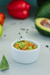 Traditional mexican avocado - vegetarian dip surrounded by its ingredients.
