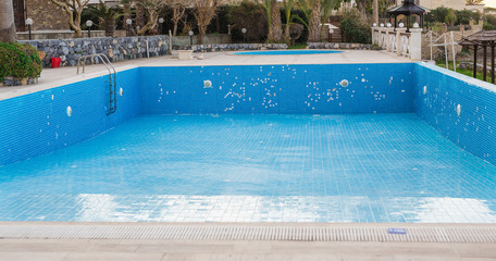 A swimming pool empties at the end of tourist season.