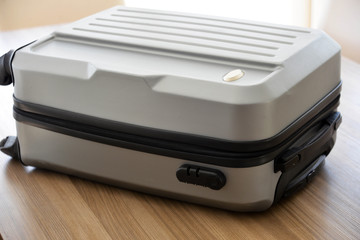 Close up of suitcase on wooden table