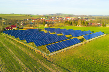 Aerial view of solar power plant. Photovoltaic power station supplying electricity to small town in...
