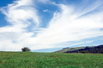 Summer landscape with dramatic blue sky above the green hills