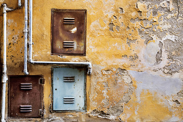old cement wall with iron pipe and doors