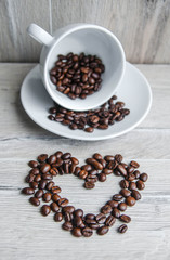 coffee beans love an cup on wooden background