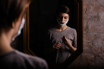 Female attempting to shave with a straight razor
