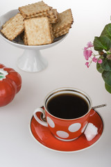 Red cup of coffee and french crackers