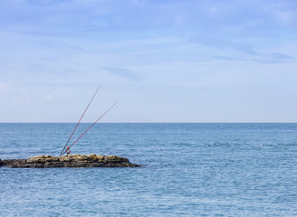 Fototapeta na wymiar Sea fishing rods on a rockky outcrop